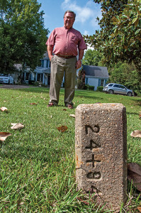 Mike Martin and the concrete obelisk he's mowed around for decades.