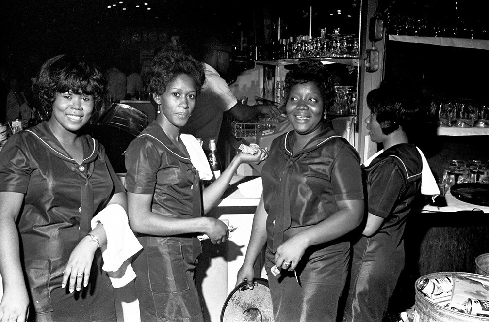 Circa 1965-68. Waitresses standing in front of a bar at the Laicos Club, Montgomery, AL. Photo by Jim Peppler.