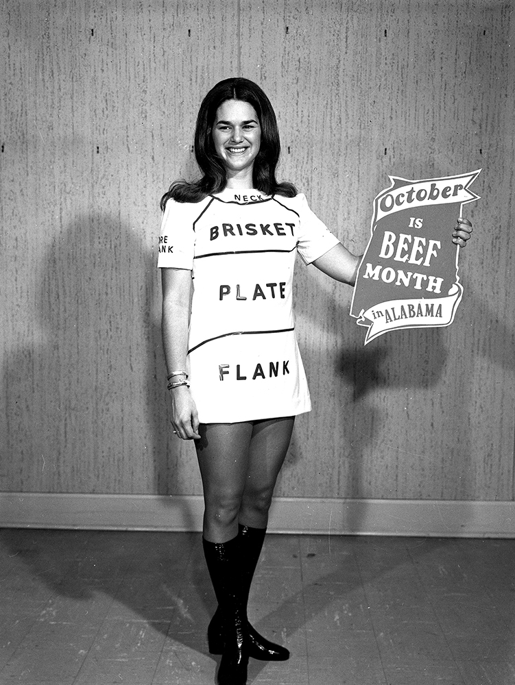 September 25, 1972. Young woman in a costume for a Beef Month promotion sponsored by the Alabama Cattlemen’s Association,. Her dress is labeled to show different cuts of beef. Photo by John E. Scott