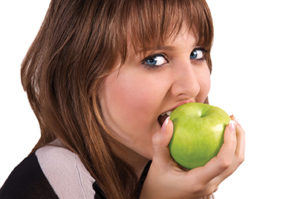 25178915 - teen girl eating an apple