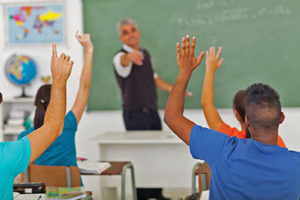 20235288 - group of students with hands up in classroom during a lesson