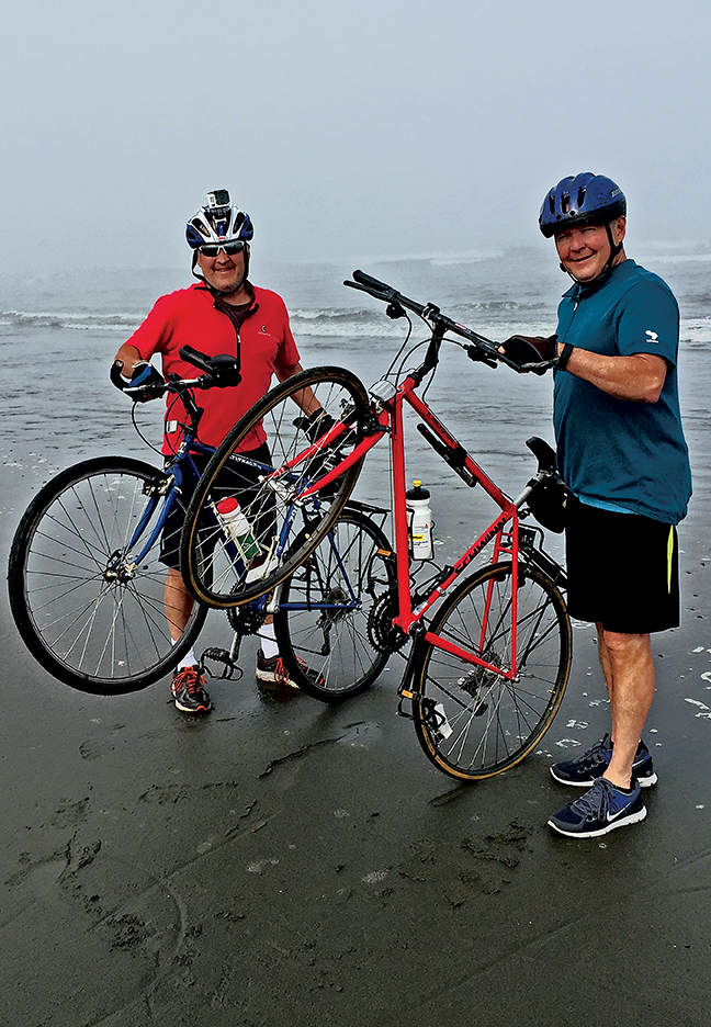 Brothers John (L) and Carl Peck (R) commemorate their 1976 cross country bike ride at the spot where it began near Eureka, CA.