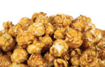 26321947 - lots of popcorn balls with sugar on a white background