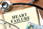 43287243 - heart failure concept. book with stethoscope and pills.
