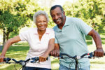 42118756 - senior african american couple cycling in park